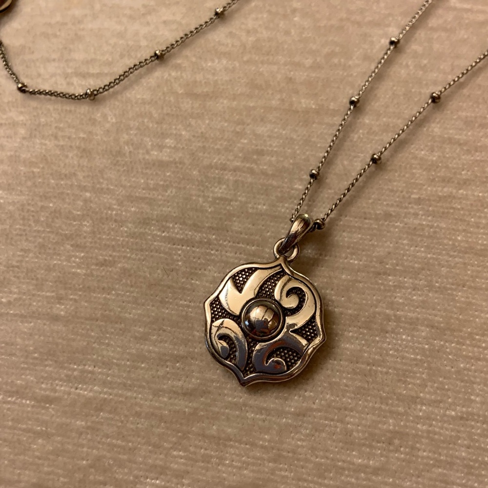 Brighton necklace with reversible charm and decorative chain.